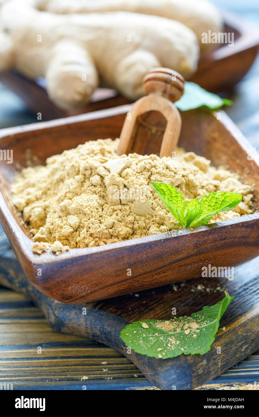 Gemahlener Ingwer in eine hölzerne Schüssel. Stockfoto