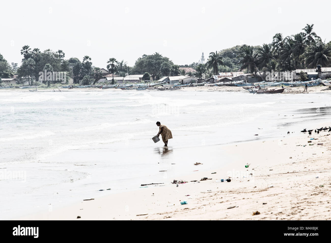 Waschen Frau Eimer im Meer Stockfoto