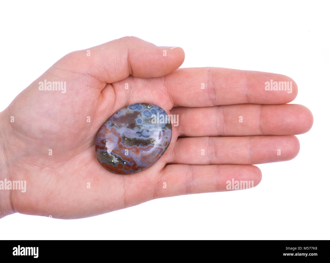 Woman's Hand poliert Ozean-achat palm Stein aus Madagaskar Stockfoto