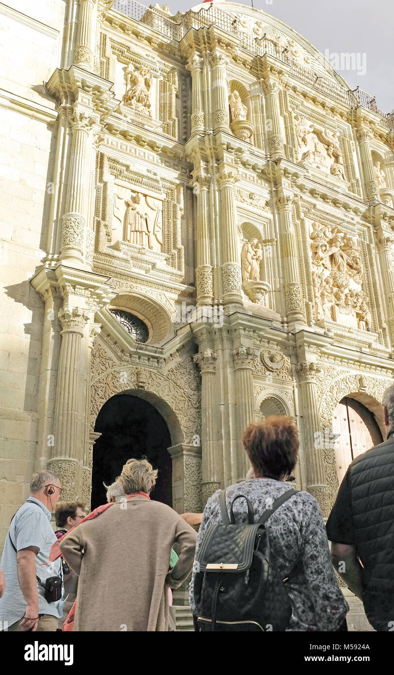 Tour Gruppe suchen, um sich an die reich verzierte Fassade der Kathedrale Unserer Lieben Frau von Annahme in Oaxaca, Mexiko. Stockfoto