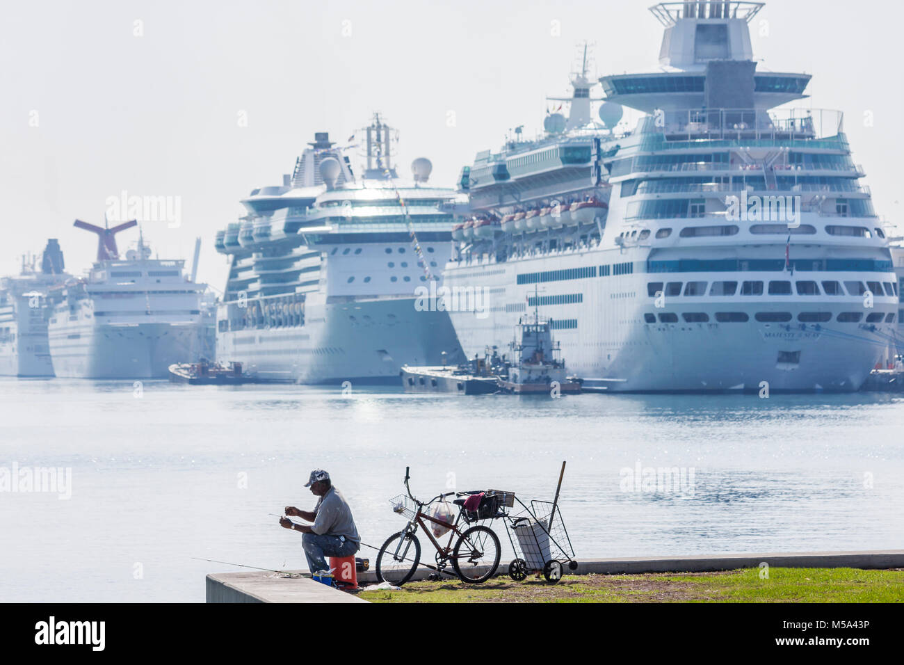 Miami Florida, Bicentennial Park, Hafen von Miami angedockt Kreuzfahrtschiffe, Mann Angeln Silhouette Fahrrad, Stockfoto