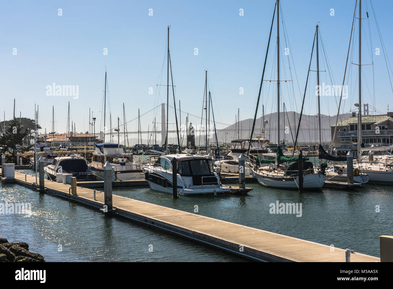 San Francisco, Kalifornien, USA - Juni 3, 2017: Segelboote im Hafen mit der Bay Bridge im Hintergrund Stockfoto