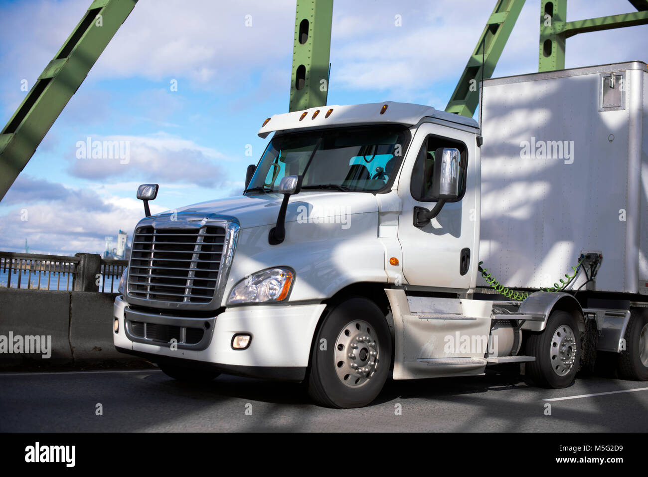 Weißes modernes Big Rig Tag cab Semi Truck mit trockenen van Auflieger für die Lieferung der kommerziellen Ladung, die auf dem Abschnitt Brücke über den Columbia River. Stockfoto