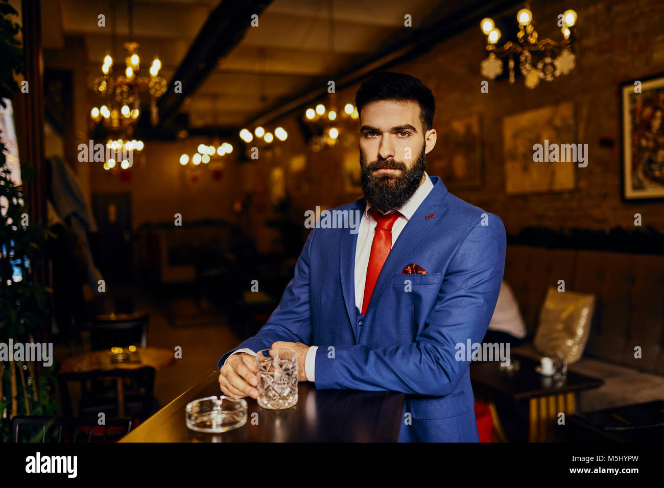 Portrait von eleganten jungen Mann in eine Bar mit Zuhaltung Stockfoto