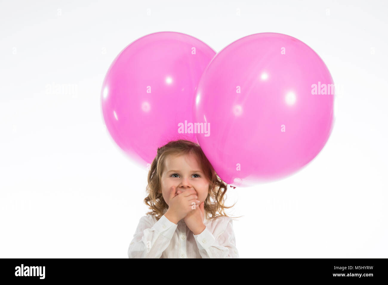 Junge Mädchen mit rosa Ballons Stockfoto