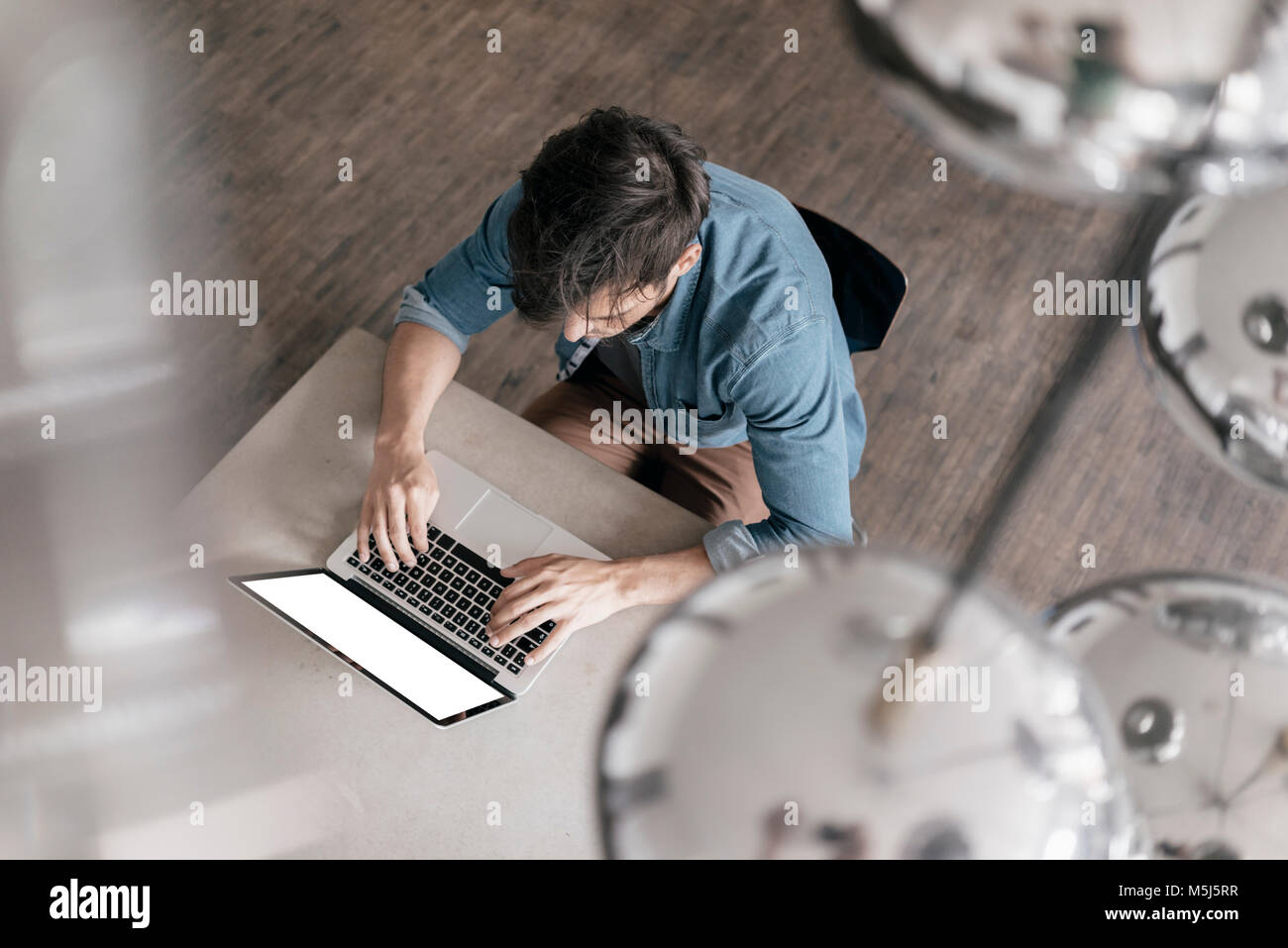 Junger Mann Arbeiten am Laptop, Ansicht von oben Stockfoto