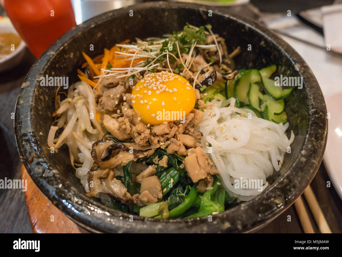 Bibimbap ist eine Südkoreanische Teller Reis mit Gemüse und einer Sauted roh oder Spiegelei. Stockfoto Bibimbap ist eine Südkoreanische Teller Reis mit Gemüse und einer Sauted roh oder Spiegelei. Stockfoto
