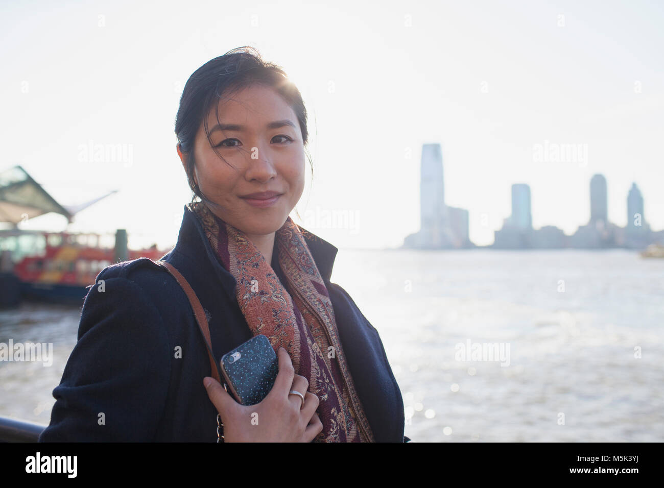 Jungen asiatischen Business woman in Kamera schaut in der städtischen Umwelt Stockfoto