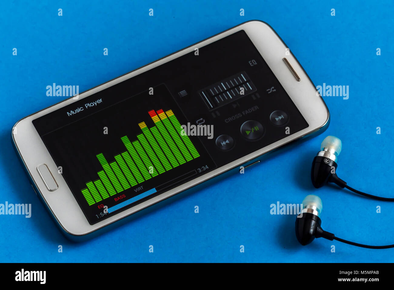 Music Player Equalizer auf dem Smartphone Display mit Kopfhörer, Nahaufnahme, blauer Hintergrund Stockfoto