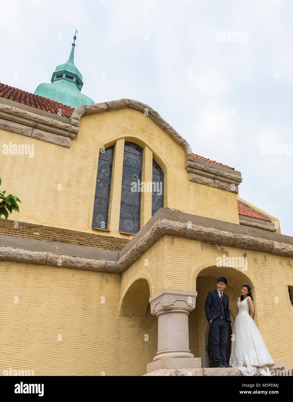 Paare, die Herde zu Qingdao evangelische Kirche zu haben, ihre Hochzeit zu fotografieren. Es ist eine der berühmten Kirchen von den Deutschen gebaut. Stockfoto