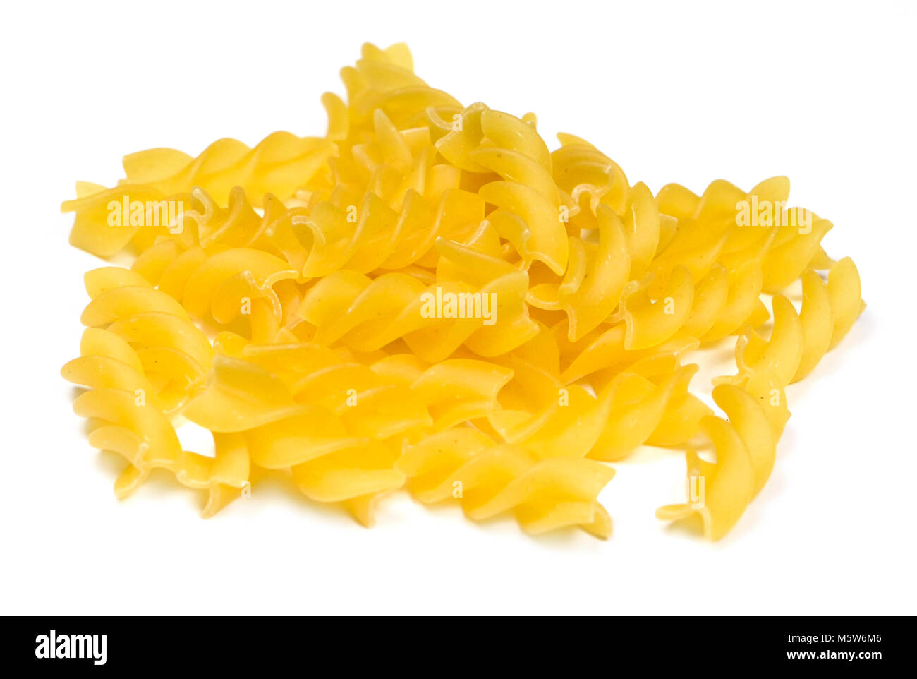 Rohe Nudeln oder trockene Teigwaren, auf weißem Hintergrund. Italienische Pasta, Nudeln fussili auf Weiß mit kopieren. Schneiden Sie Lebensmittel oder Zutaten. Stockfoto