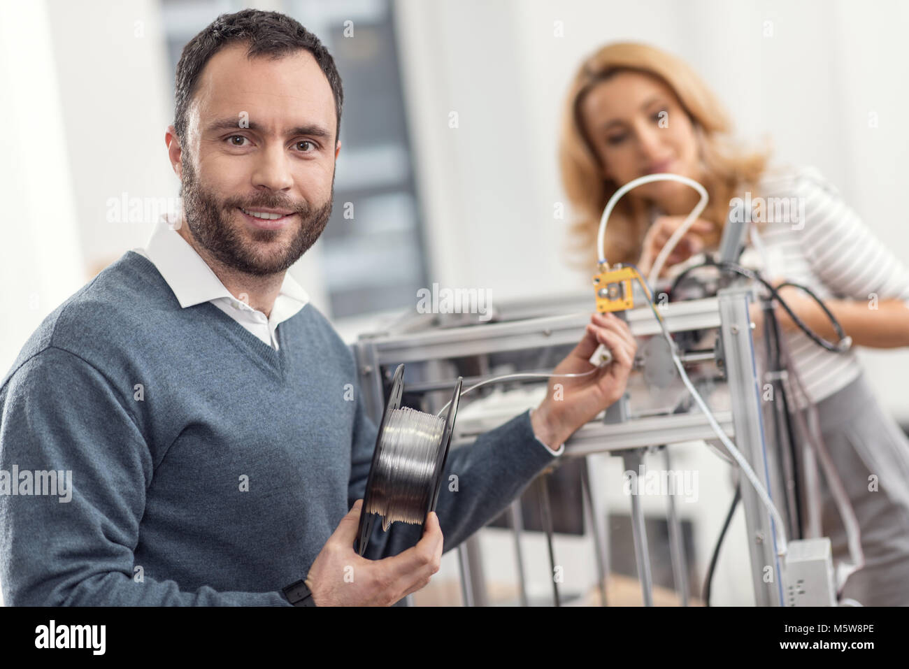 Charmante Ingenieur Lächeln beim Austauschen der Glühlampe Stockfoto