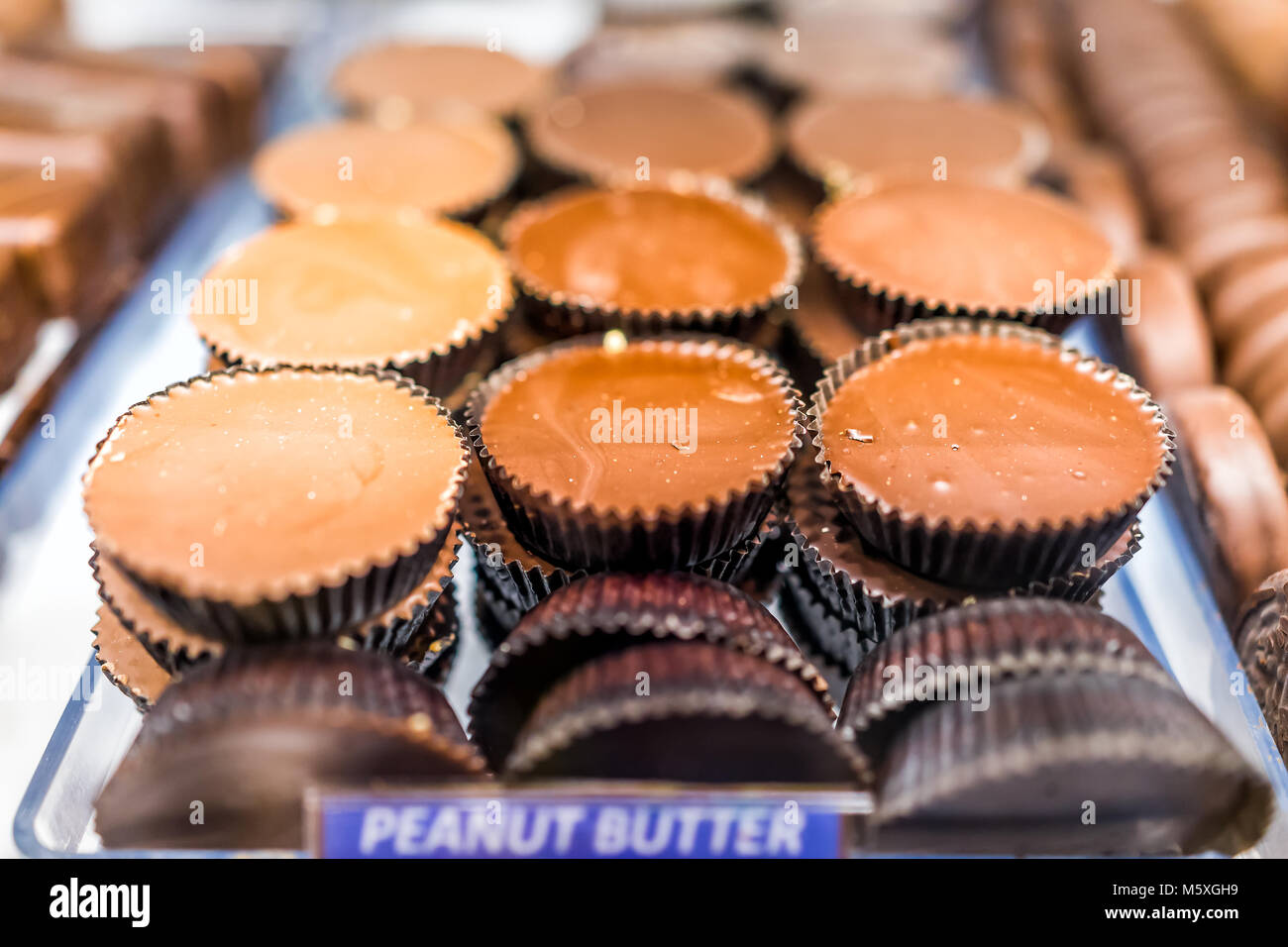 Makro Nahaufnahme von Chocolate Peanut Butter cups Bars candy süße Nachspeise behandelt mit Vorzeichen auf Fach Anzeige in Store, Shop, Bäckerei, Cafe Stockfoto