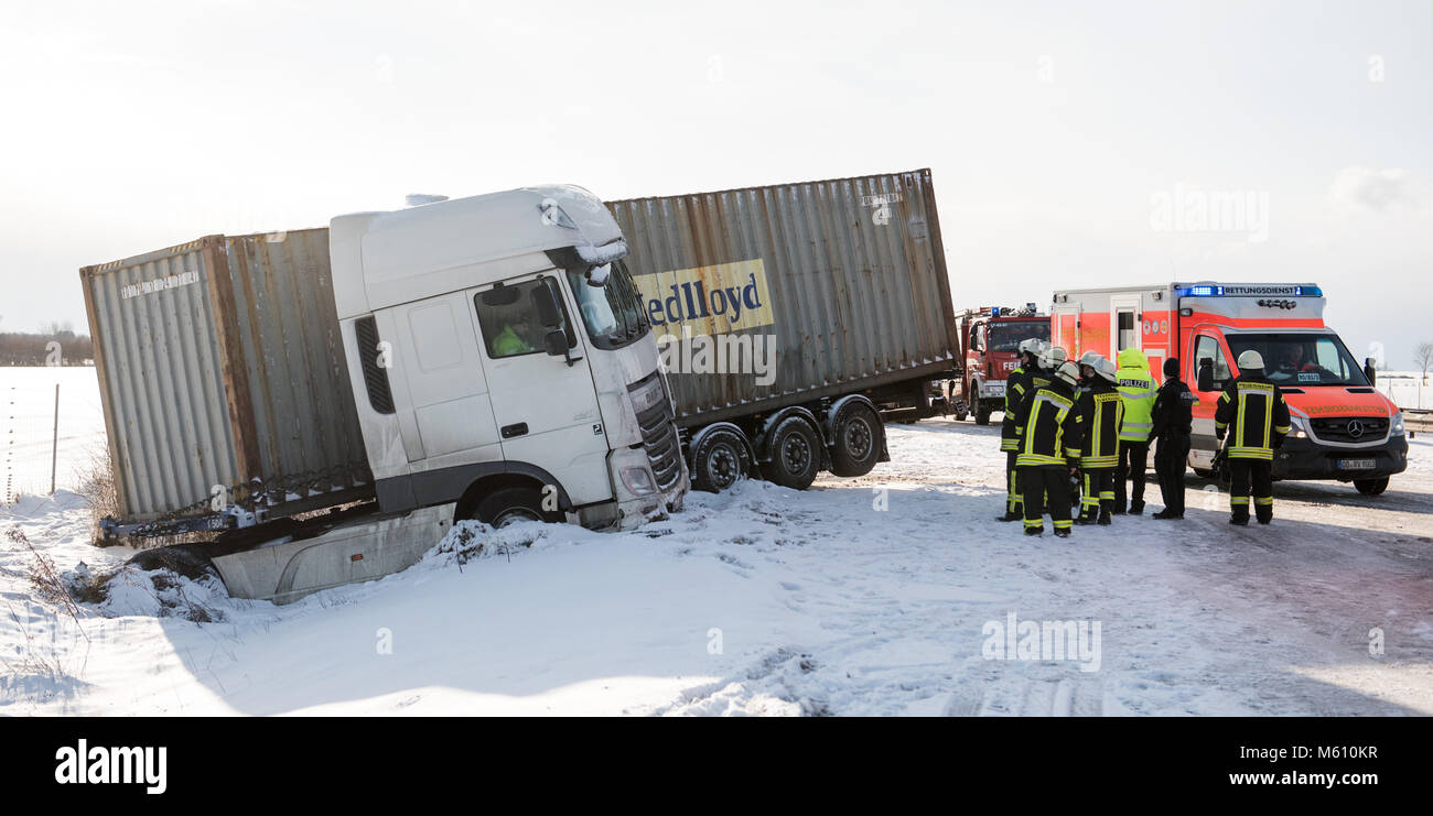 Talkau, Deutschland. 27 Feb, 2018. Ein Lkw liegt in einem Graben auf der Autobahn nach einem Unfall auf der Autobahn Auf eisglatten Strassen. Mehrere Personen wurden bei dem Unglueck verletzt. Foto: Daniel Bockwoldt/dpa Quelle: dpa Picture alliance/Alamy leben Nachrichten Stockfoto