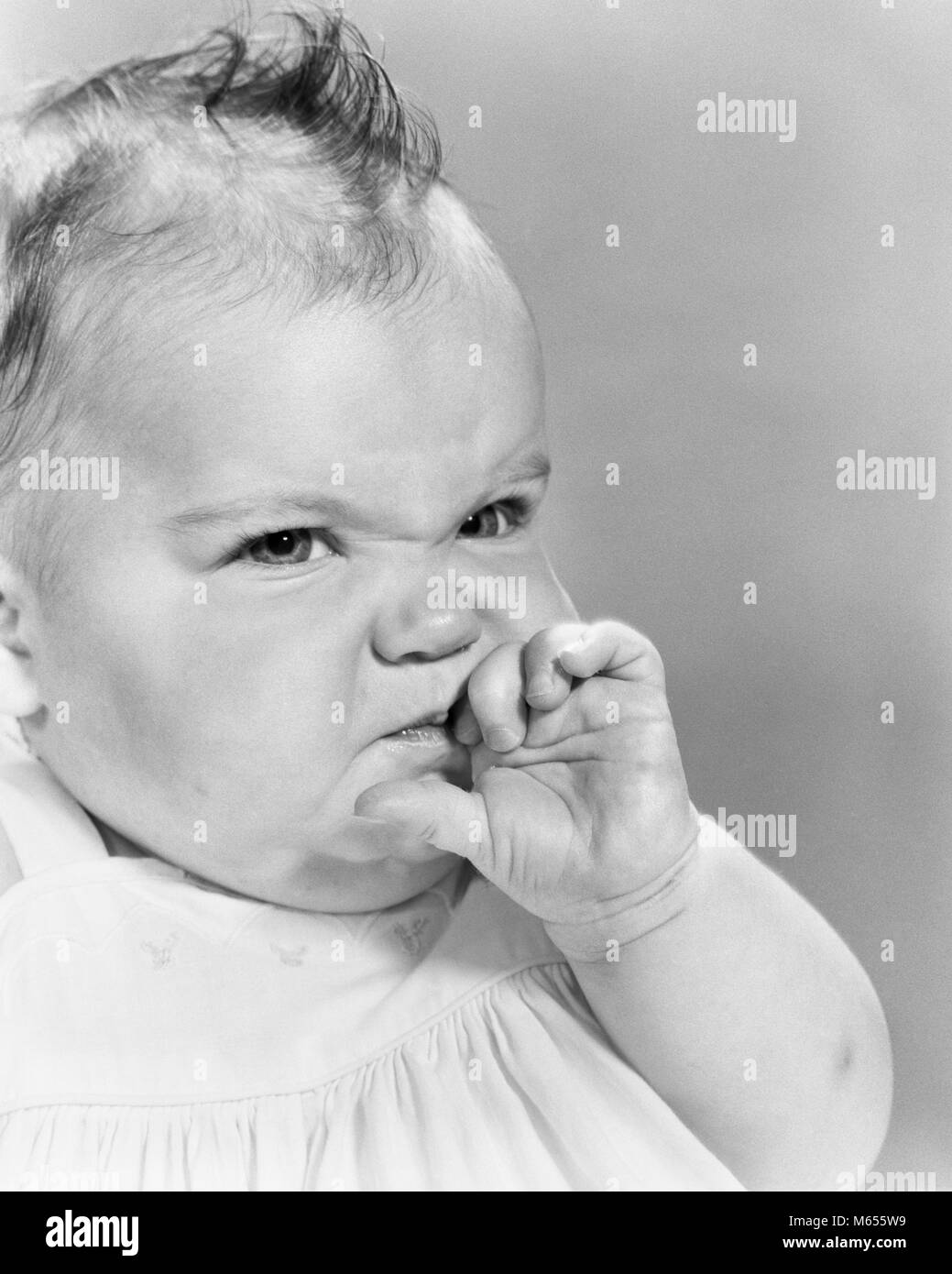 1950er Jahre 1960er Jahre BABY GIRL, Funny Face von der Hand in den Mund rümpfte die Nase zeigen Abneigung schlechten Geschmack EKEL-b 12621 HAR 001 HARS GESCHMACK 6-12 MONATE EMOTION emotionale Gefühle JUGENDLICHE SAURE EINSTELLUNG B&W BABY GIRL SCHWARZ UND WEISS KAUKASISCHEN ETHNIE VERHALTEN MAG ALTMODISCH Stockfoto