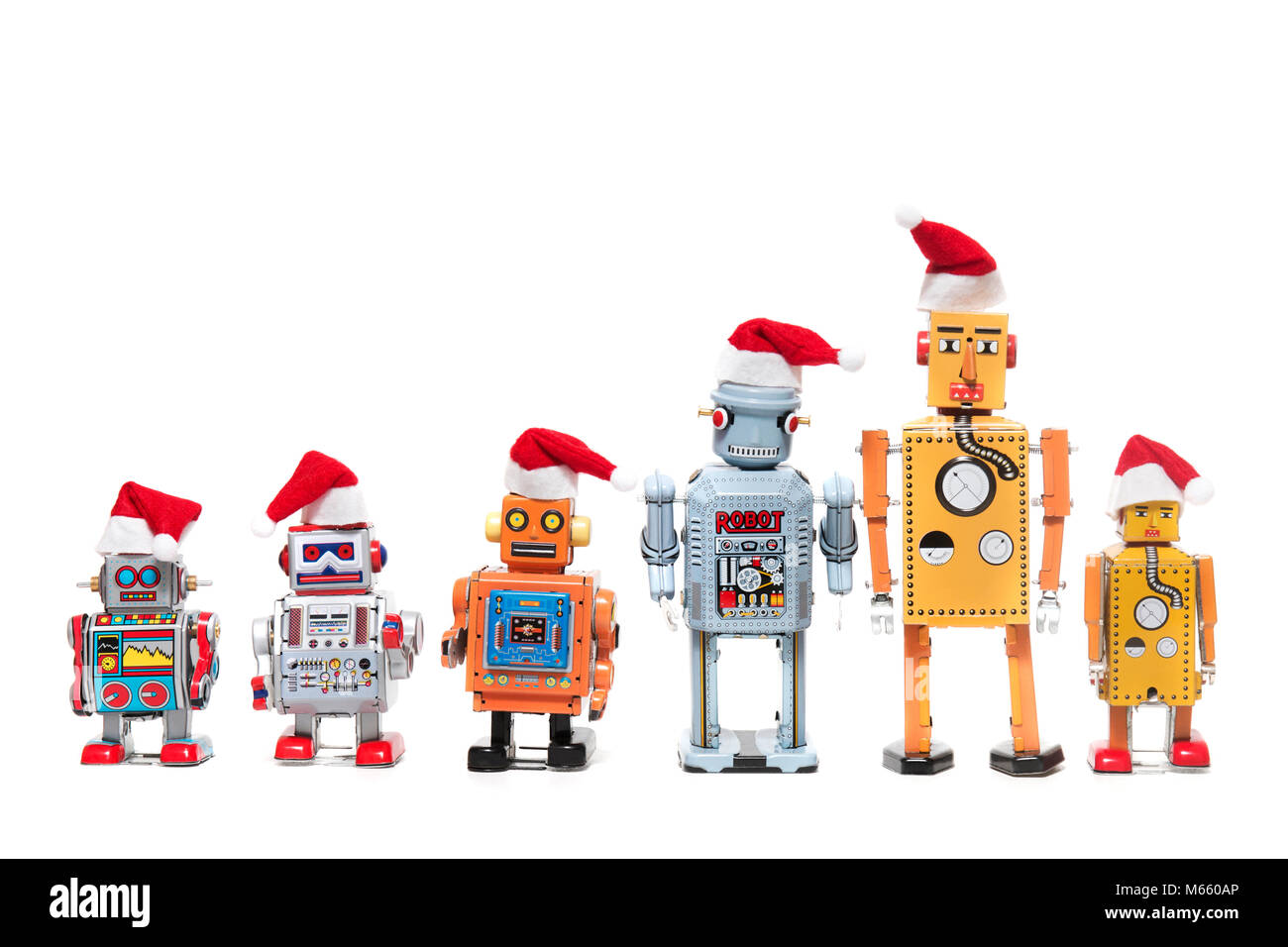 Vintage Zinn Roboter Spielzeug mit xmas Hüte auf einem weißen Hintergrund. Stockfoto