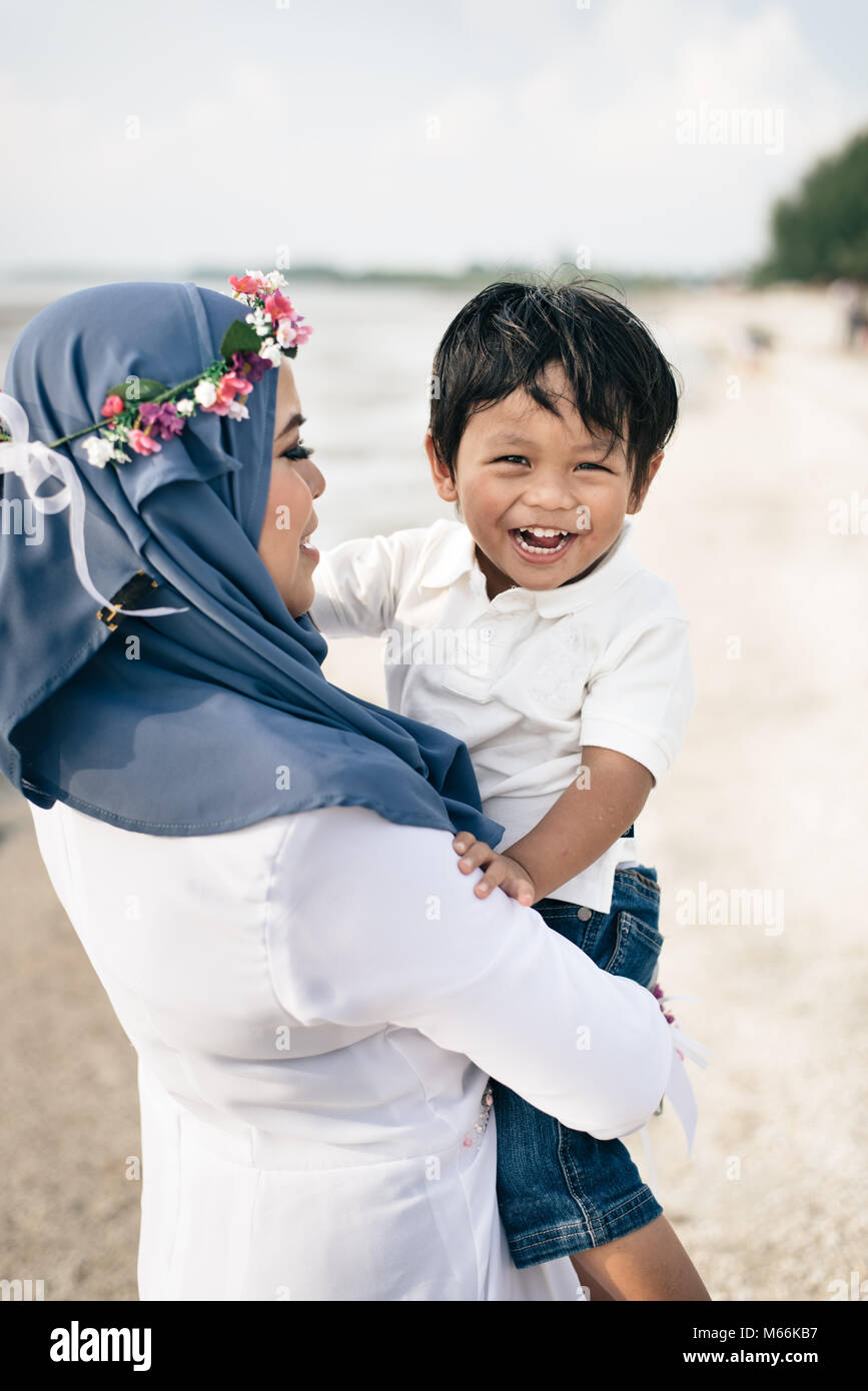 Lieben jungen asiatischen Mutter mit ihrem Sohn zu lächeln und zu lachen am Strand. familienkonzept Stockfoto