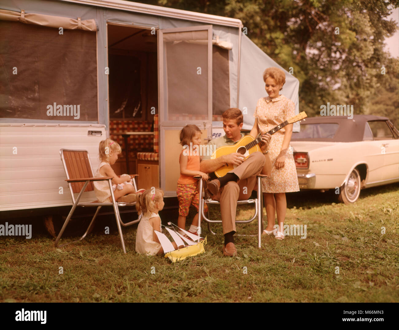 1960 FAMILIENURLAUB RV POP-UP CAMPER MUTTER DREI KINDER ALLE MÄDCHEN VATER  SITZEN Gitarre spielen - km 1524 HAR 001 HARS BEZIEHUNG MÜTTER ALTE ZEIT  OLD FASHION SCHWESTER KINDER KOMMUNIKATION BLOND FERIENHÄUSER KAUKASISCHEN