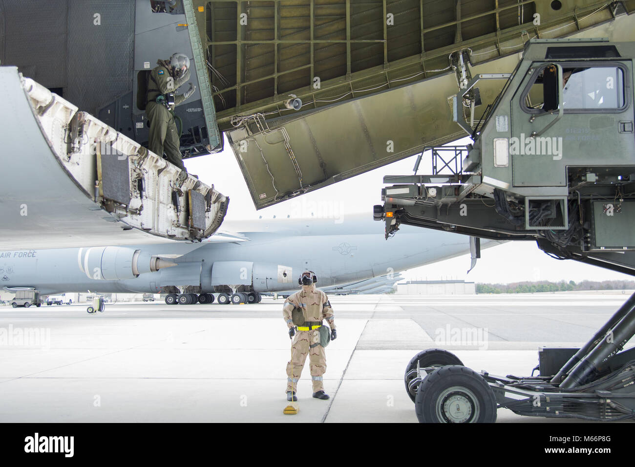 Team Dover Flieger offload eine C-5 M Super Galaxy tragen volle MOPP gear während der 2018 Vengeant Eagle Übung Feb.22, 2018 in Dover Air Force Base, Del. Eine der vielen Aufgaben, die während der Übung war zu landen offload Cargo in einer simulierten verschmutzte Umwelt und. (U.S. Air Force Foto von Mauricio Campino) Stockfoto