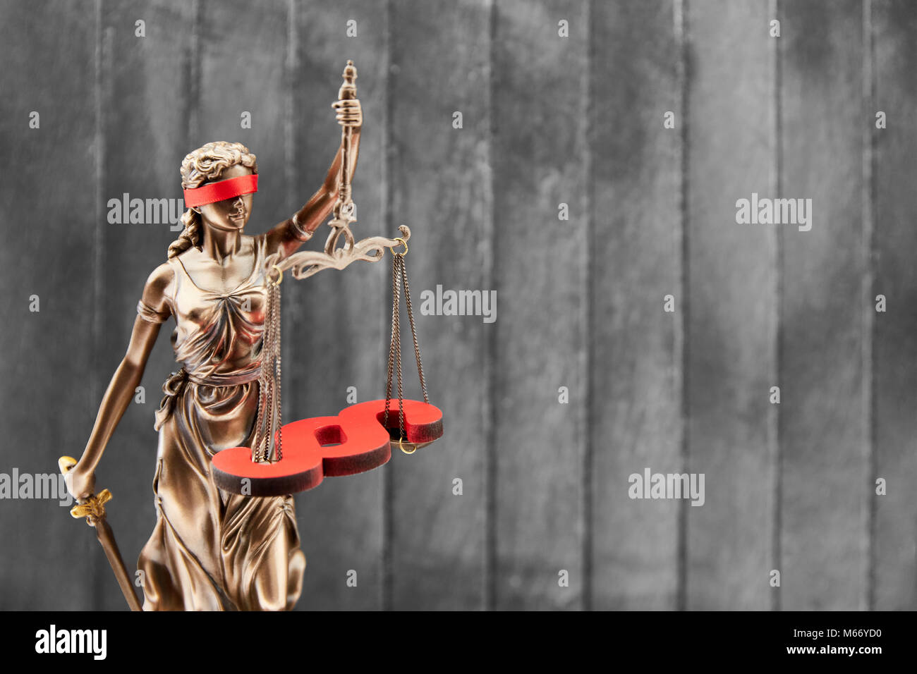 Blinde Justitia mit Waage und Absatz vor Holz Hintergrund als Gesetz Konzept Stockfoto