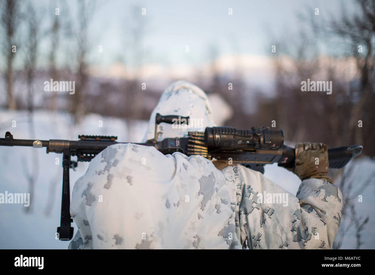 Marine mit Marine Rotational Force-Europe fährt in Position vor der Durchführung einer bergigen Angriff auf feindliche Position während der Bereich Ausbildung übung Teil der Übung weiß Claymore in der Nähe von Bardufoss, Norwegen, 15. Februar 2018. Weiß Claymore ist einer in Großbritannien Royal Marines - LED-Training in Nordnorwegen, auf Winter Kriegsführung, einschließlich Schulung auf Bewegung im negativen Terrain und über Schnee konzentriert, und die Ausbildung in defensive und offensive Operationen bei winterlichen Bedingungen. (U.S. Marine Corps Stockfoto