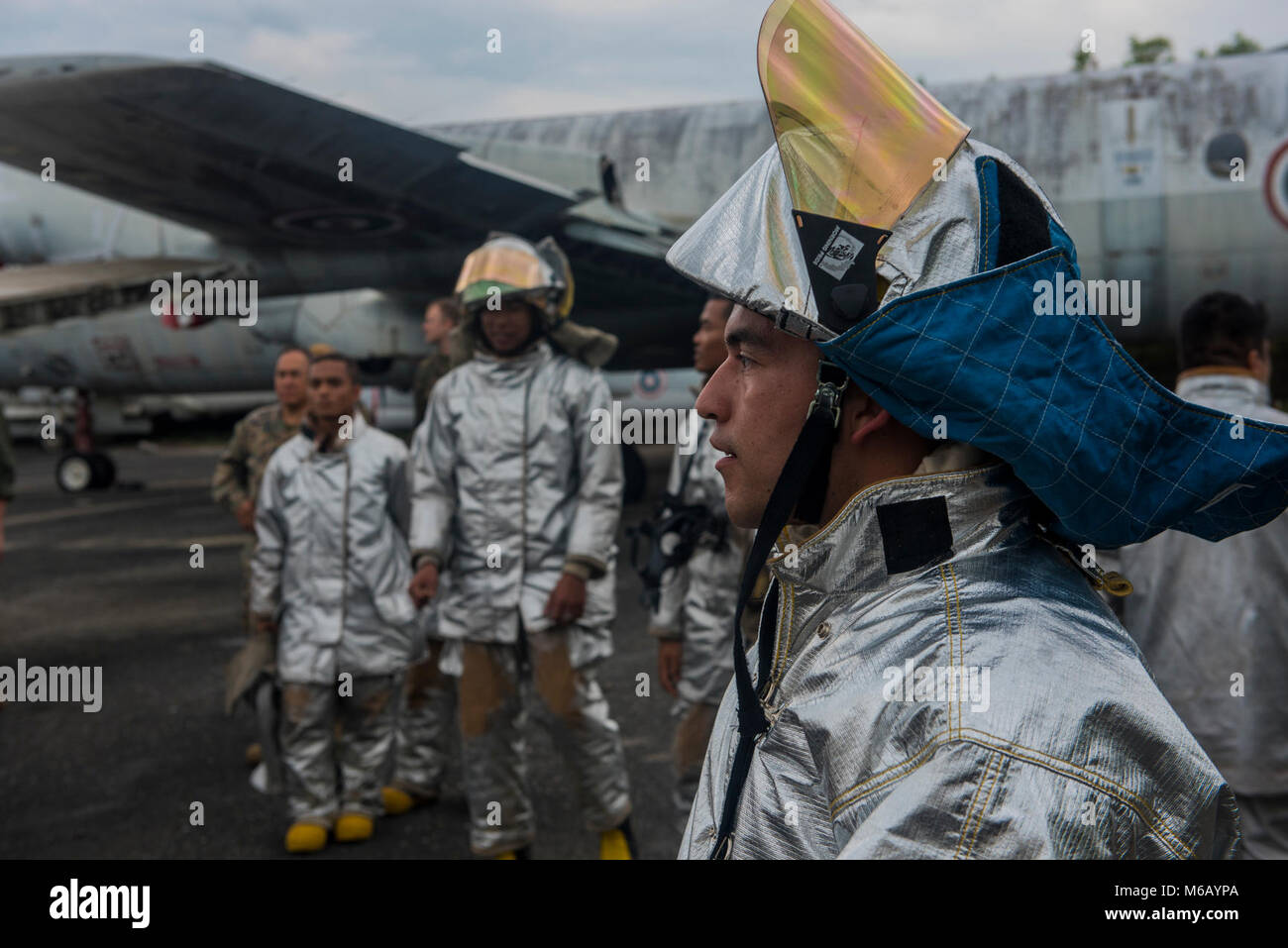 Us Marine Corps Cpl. Jorge Vega von Los Angeles, ein Feuerwehrmann mit Marine Expeditionary Wing Support Squadron 172, Uhren eine Demonstration auf, wie man eine K-12-Säge mit Feuerwehrmänner vom Royal Thai Navy Feb.20, 2018, während Flugzeuge Extraktion Ausbildung bei U-Tapao International Airport, Provinz Rayong, Thailand. Nach der Extraktion der Ausbildung, die kombinierte Löschteam führte eine Live Brennen simulieren ein Flugzeug zum Absturz bringen. Die bilateralen Training, als Teil der Übung Cobra Gold 2018 durchgeführt wurde, konnten die Feuerwehrleute einen eingehenden Blick auf, wie der andere Dienst betreibt. Cobra Gold, in Es Stockfoto