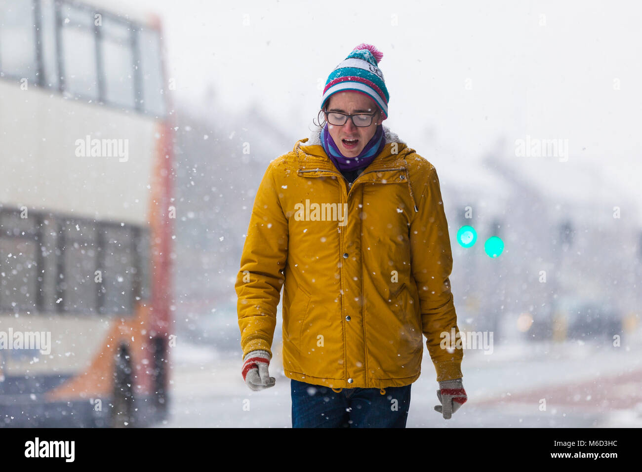 Ashford, Kent, Großbritannien. 2 Mär, 2018. UK Wetter: Tier aus dem Osten. Schnee in Ashford, Kent. Die Menschen machen es Weg zurück von der Arbeit als weiterer Aufregung der Schnee geht über die Innenstadt. Die Temperaturen haben sich verbessert, aber mit dem Wind Faktor ist es immer noch -5 C. Dieser junge Mann trotzt der Kälte. Photo Credit: PAL Bilder/Alamy leben Nachrichten Stockfoto