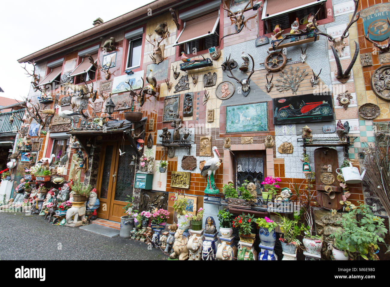 Stadt Molsheim, Frankreich. Malerische Ansicht einer Molsheim Zentrum Haus Fassade, Schmuck, Spielzeug und Blumentöpfe abgedeckt. Stockfoto