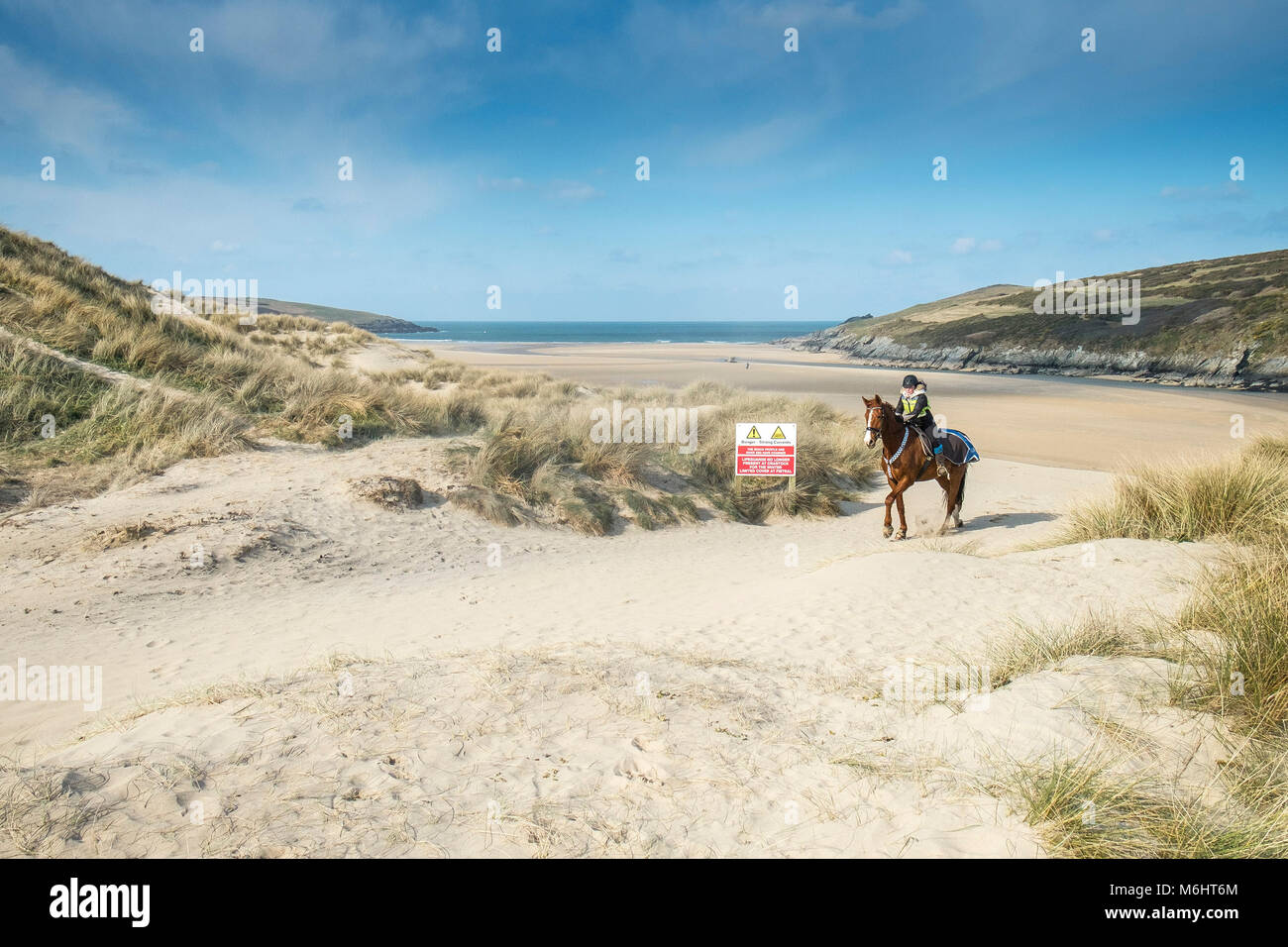 Ein Pferd Reiter auf den Sanddünen bei Crantock Beach in Newquay Cornwall. Stockfoto