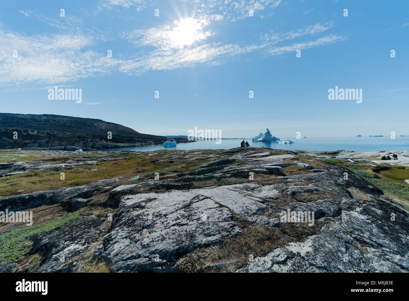 2 Menschen auf der Bank vor der Eisberge, Grönland Stockfoto
