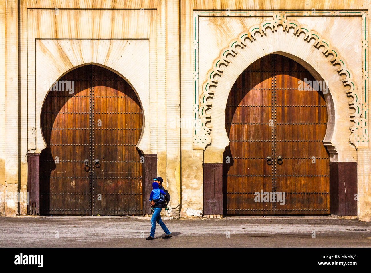 Lokale Mann mit kleinen Kind in die Arme vor der Bab Jdid Dkaken, Fes Bereich der kaiserlichen Stadt Fes, Marokko. Stockfoto