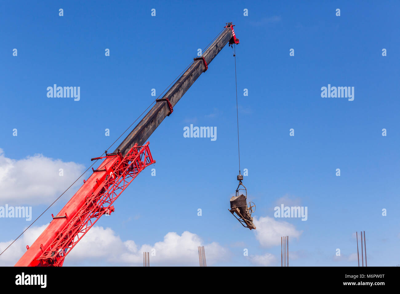 Bau industrie Baustelle Autokran Kabelhaken mit hängenden mechanische Schaufel für das Gießen von Beton Zement Lieferung an Stahl Foundation Stockfoto