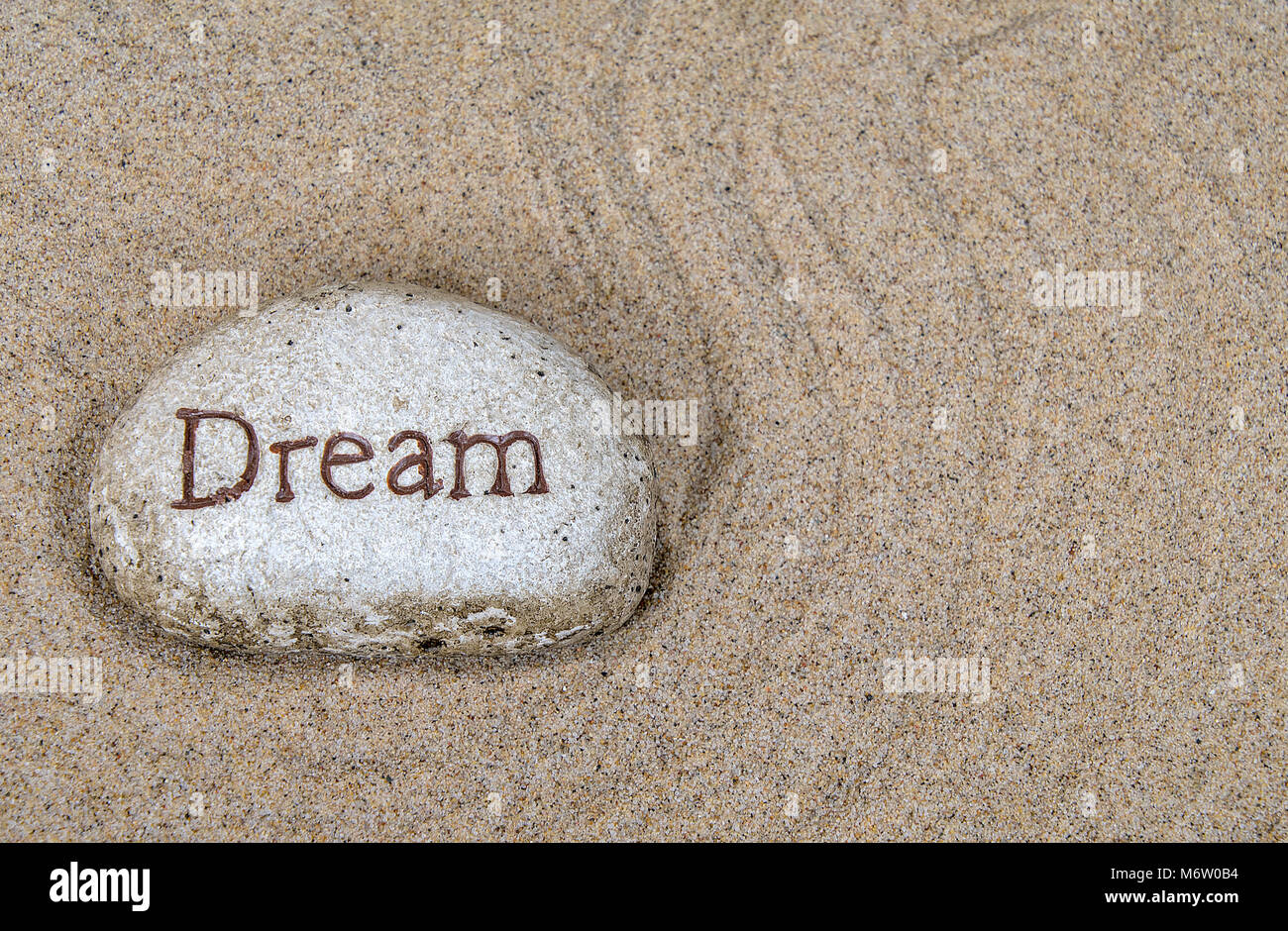 Nahaufnahme der Stein mit Traum Anmelden geharkten Strand sand Pattern Stockfoto