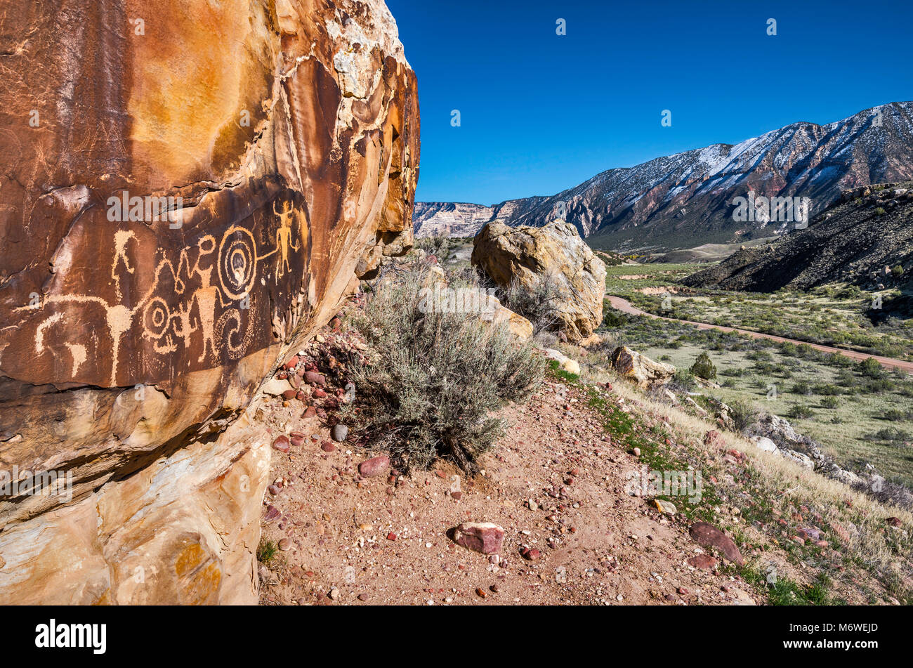 McKee Federn Petroglyphen, Fremont Kultur Rock Art Panel, Split Berg im Hintergrund, Insel der Park Road, Dinosaur National Monument, Utah, USA Stockfoto