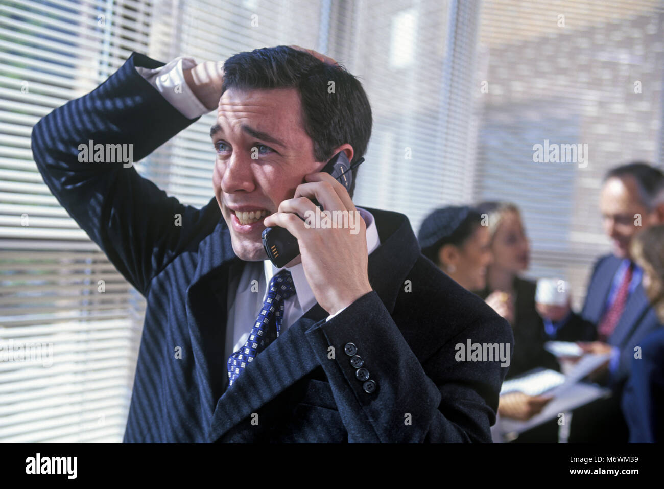 1998 historische KAUKASISCHEN GESCHÄFTSMANN TAGUNG IM KONFERENZRAUM HOLDING MOBILE MOBILTELEFON Stockfoto
