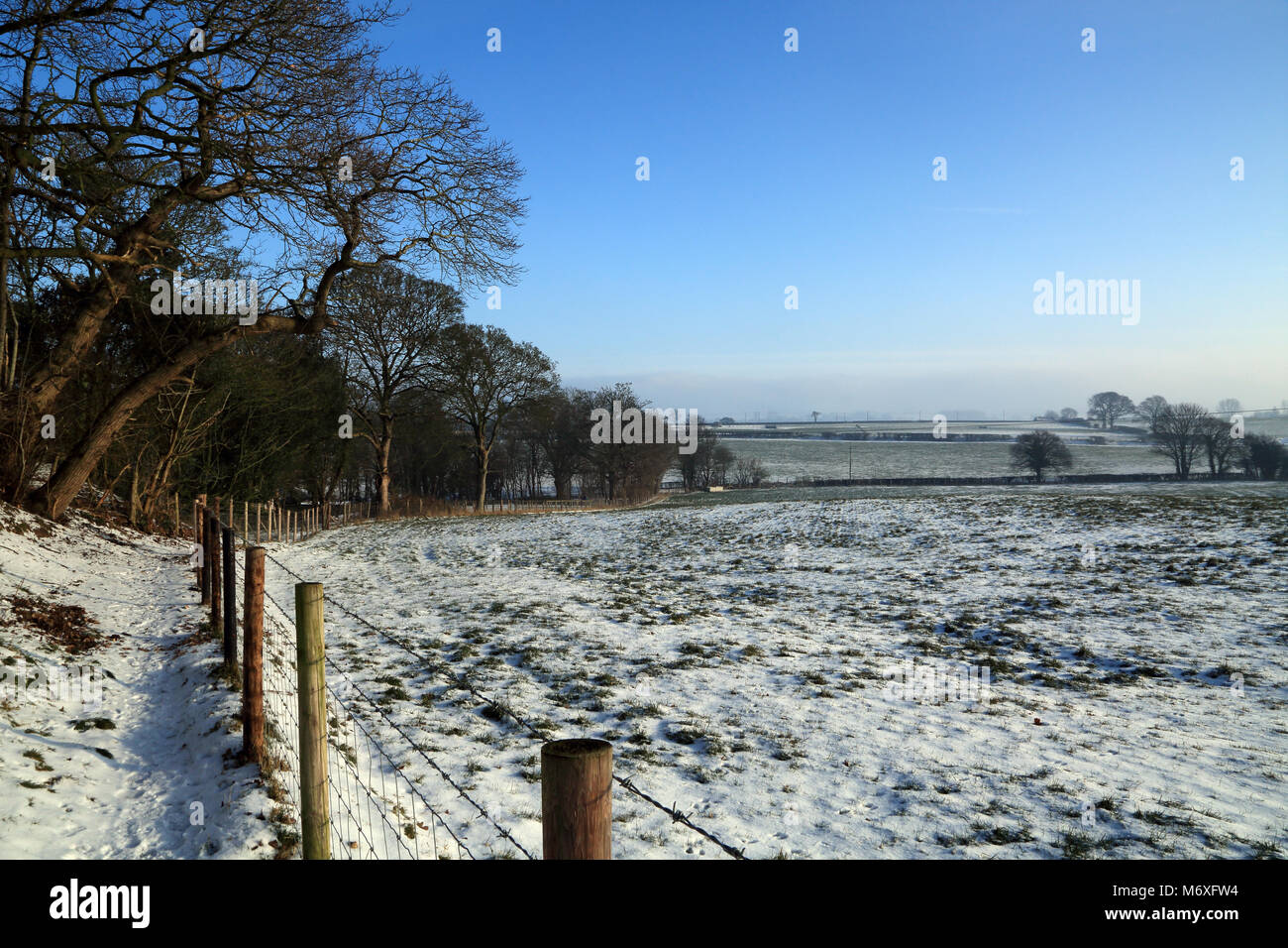 Blick auf Fußweg und Zaun Begrenzung zu schneebedeckten Feld am Ortsrand von Brabourne Lees in der Nähe von Ashford, Kent, Vereinigtes Königreich Stockfoto