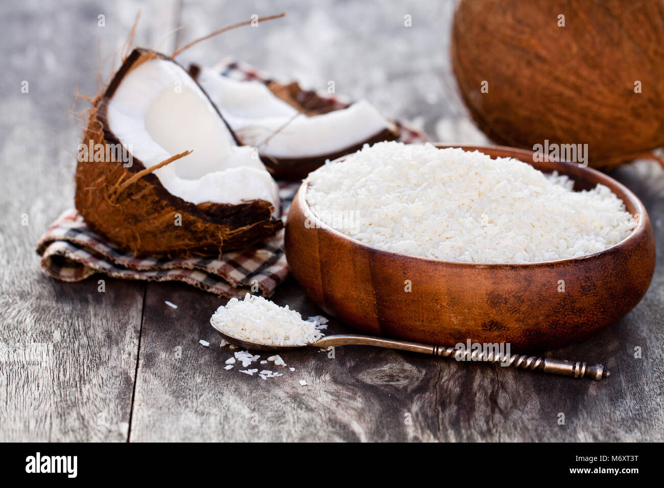 Risse coconut und Flocken auf rustikalen Holztisch Hintergrund Stockfoto