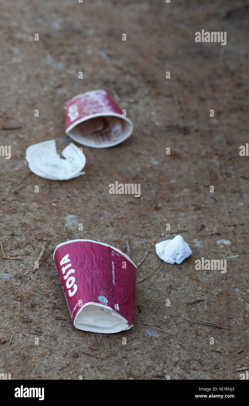 Kaffeetassen links am Boden als Abfall. Stockfoto