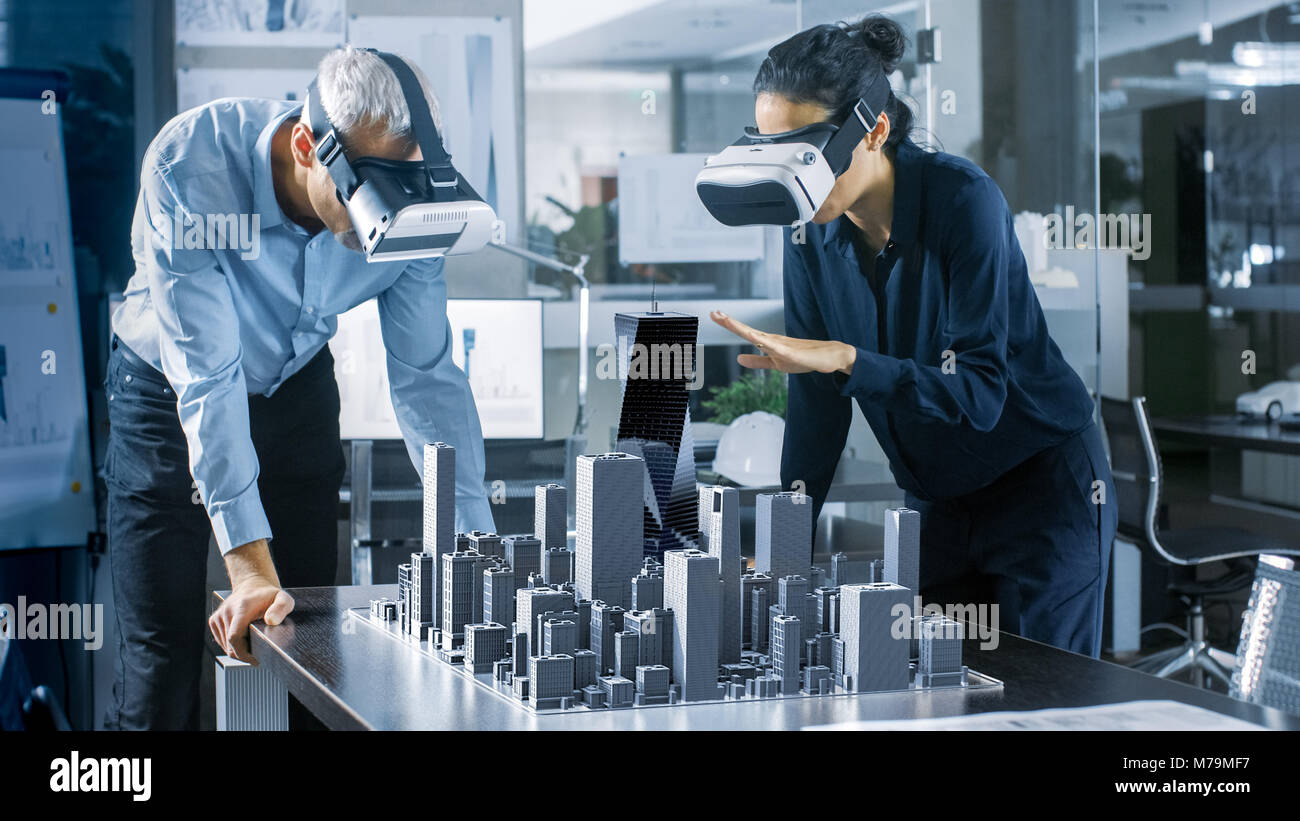 Männlichen und Weiblichen Architekten tragen Augmented Reality Headsets Arbeiten mit 3D-Stadtmodell. High Tech Office Professional Menschen Virtuelle Realität Modell Stockfoto