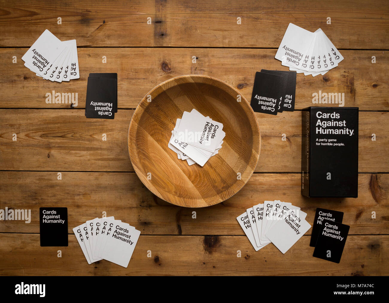 Karten gegen die Menschlichkeit, ein Party Spiel für grausamen Menschen, dargestellt auf einem Holztisch Stockfoto