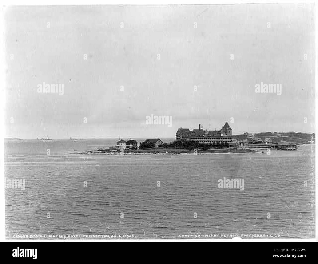 Dieses Foto zeigt Boston Light und das Hotel Pemberton in Hull, Massachusetts, zwei prominente Wahrzeichen, die einen Einblick in den Charakter und die Geschichte der Stadt an der Küste bieten. Stockfoto