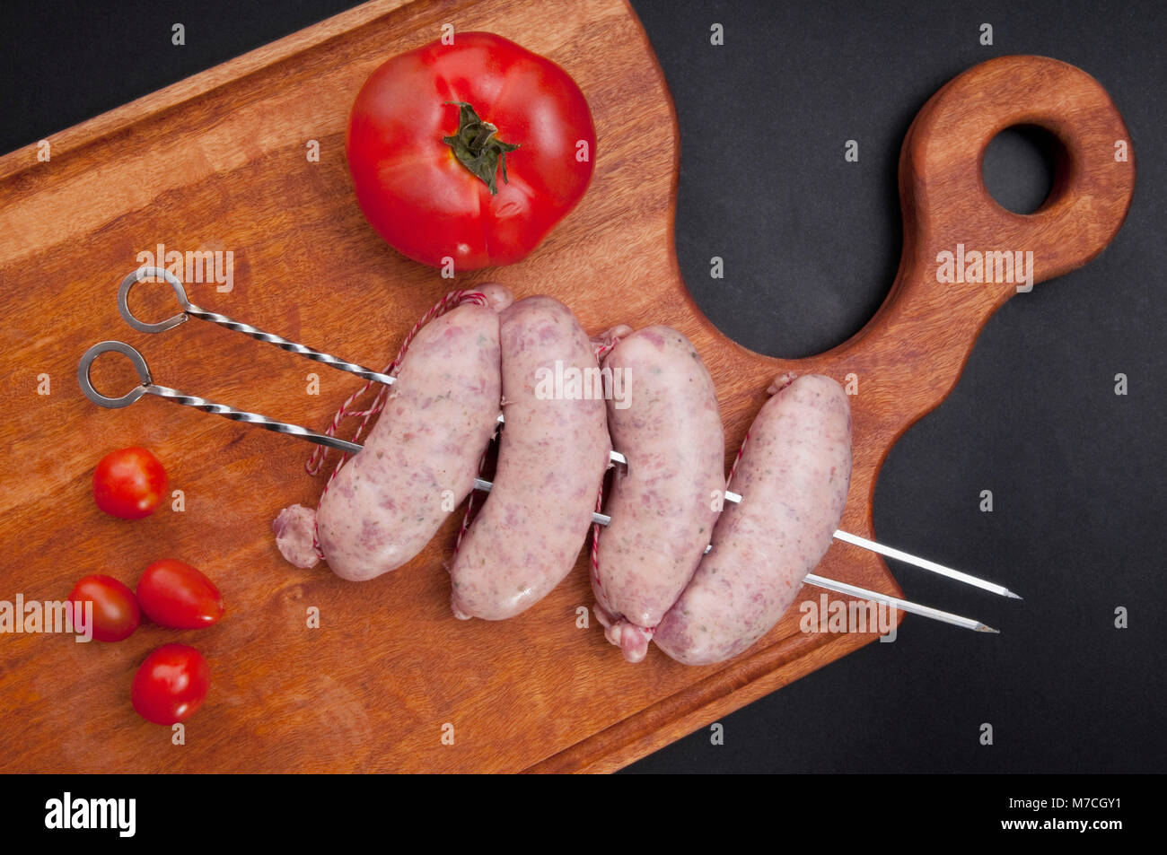 Erhöhte Ansicht von Würsten in Spieße auf Schneidebrett Stockfoto