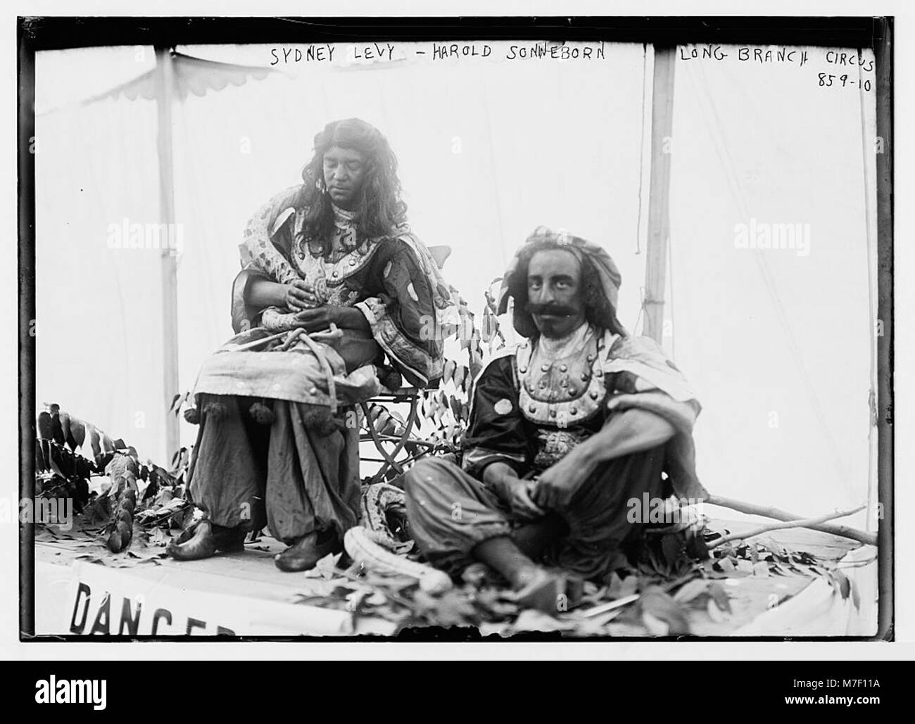 Sydney Levy und Harold Sonneborn, kostümiert für einen Auftritt im Society Circus in Long Branch. Das Foto fängt die farbenfrohen, theatralischen Kostüme und die festliche Atmosphäre der Zirkusszene des frühen 20. Jahrhunderts ein. Stockfoto