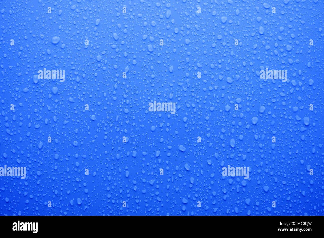 Wassertropfen auf Deep Blue Oberfläche als Hintergrund Stockfoto