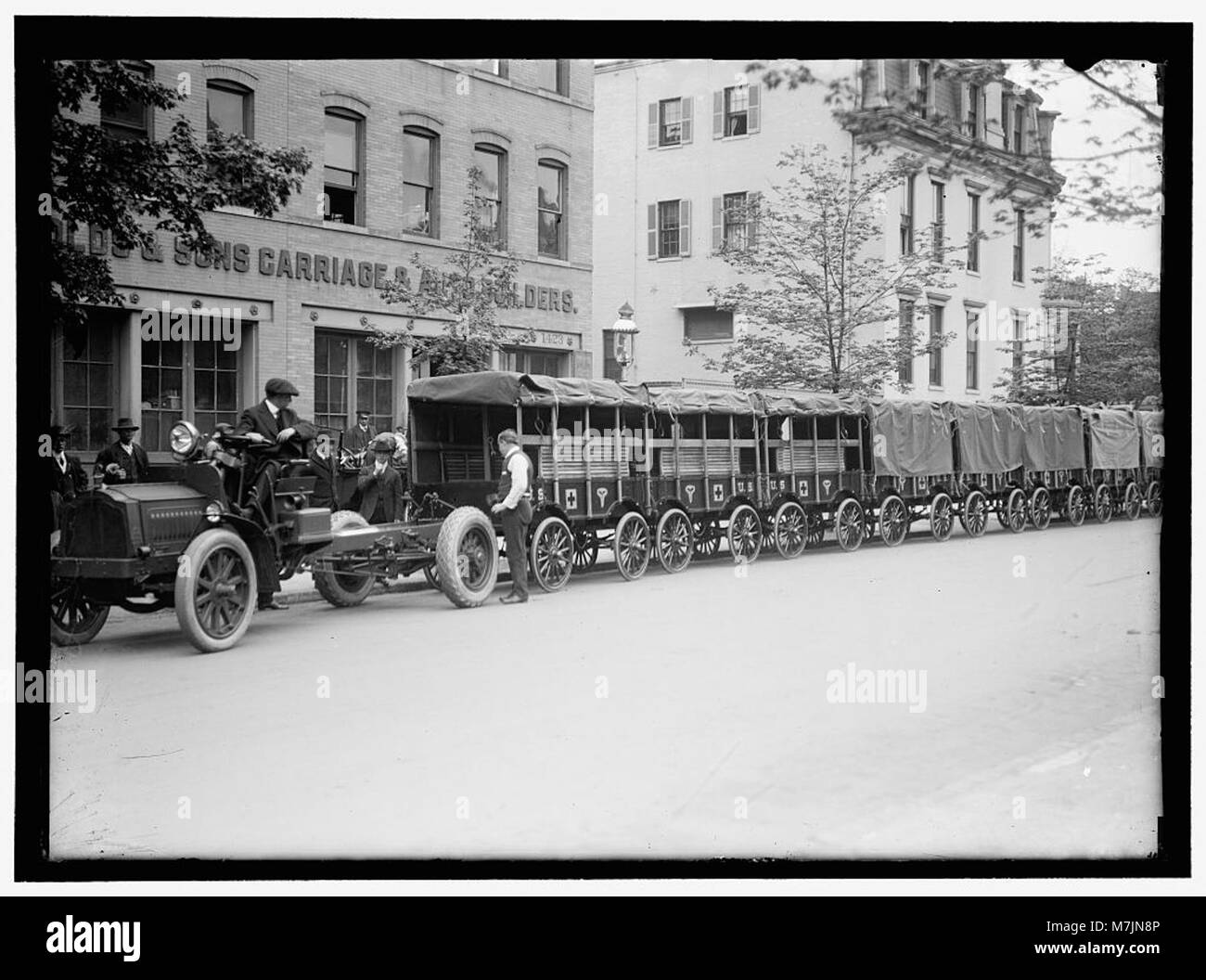 Dieses Bild zeigt Armeewagen und Anhänger des amerikanischen Roten Kreuzes, die mit Vorräten beladen sind und Teil der Bemühungen sind, Hilfe während des Krieges oder Katastrophenschutzes zu leisten. Stockfoto