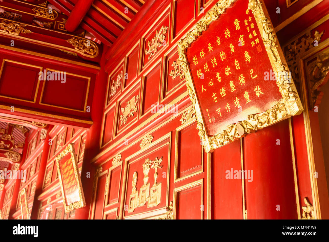 Reich verzierten Holzpaneelen, lackiert in Rot und Gold in Cần Điện Chánh (Can Chanh Palast) Hoàng thành (Imperial City) ein von Mauern umgebene Zitadelle 1804 in Hue, Vietnam gebaut. Stockfoto