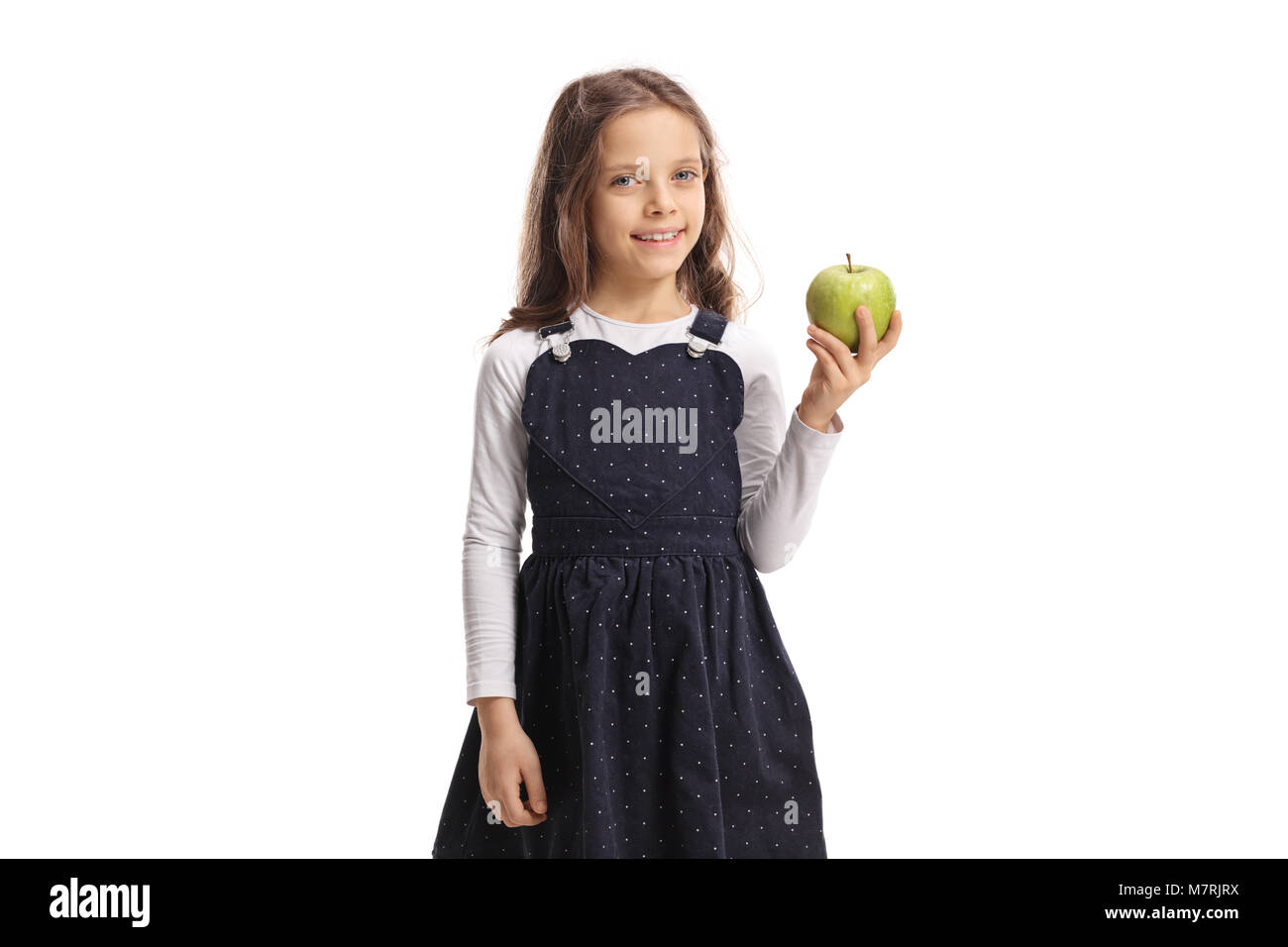 Süße kleine Mädchen mit einem Apfel und lächelnd auf weißem Hintergrund Stockfoto