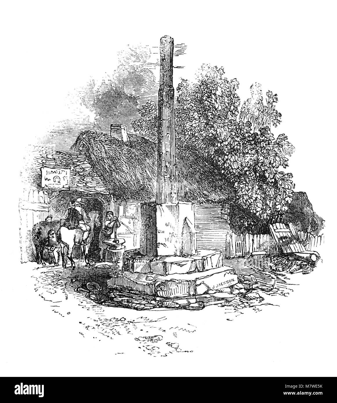 Schmied und Schmiede in der Nähe der Überreste einer alten Kreuz auf dem Gelände der Abtei, in Geisa Geisa in Worcestershire, England. Das Hauptgebäude wurde um 1100 begonnen und im Jahre 1539 aufgelöst. Die Abtei Kirche blieb im Einsatz als Pfarrkirche Stockfoto