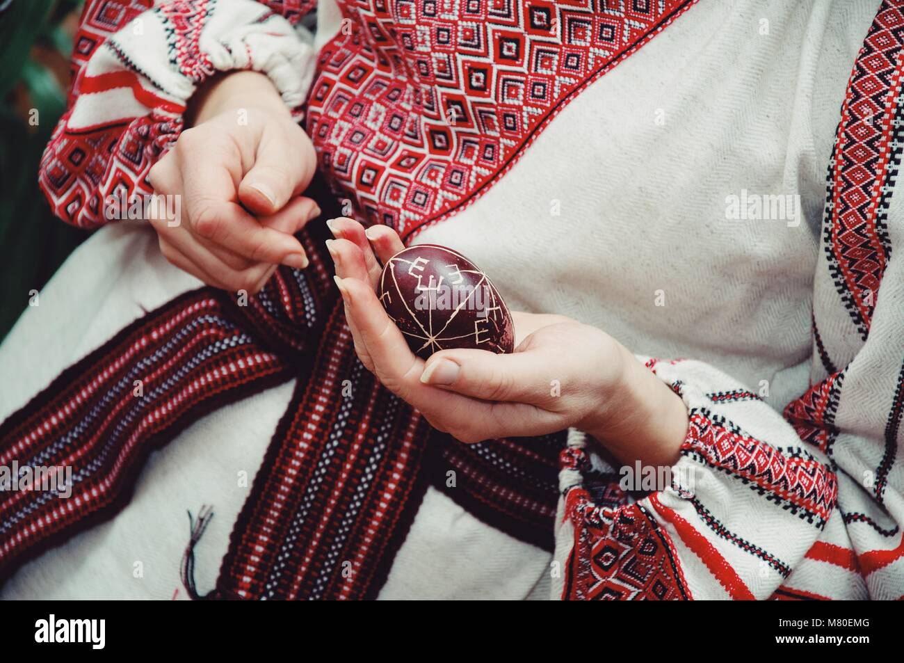 Frau in Tracht holding Osterei Stockfoto