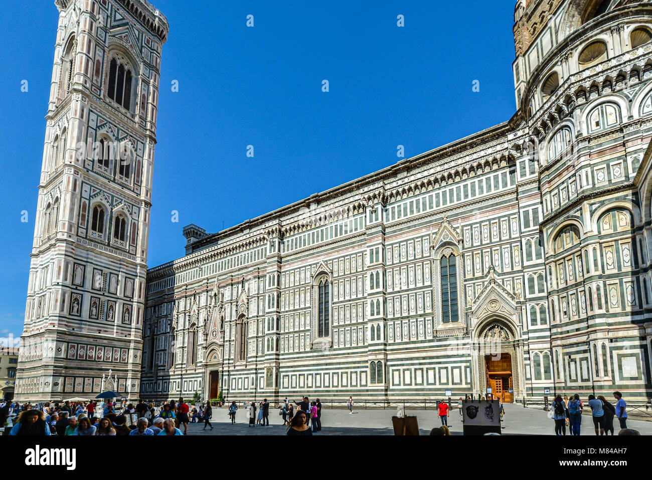 Die beeindruckende Fassade der Kathedrale von Florenz, Campanile und Dom an einem sonnigen Sommertag mit Touristen in der toskanischen Stadt von Florenz, Italien Stockfoto